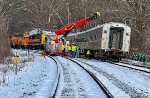 I'm guessing that the coaches are being lifted so that rail can be restored under them?